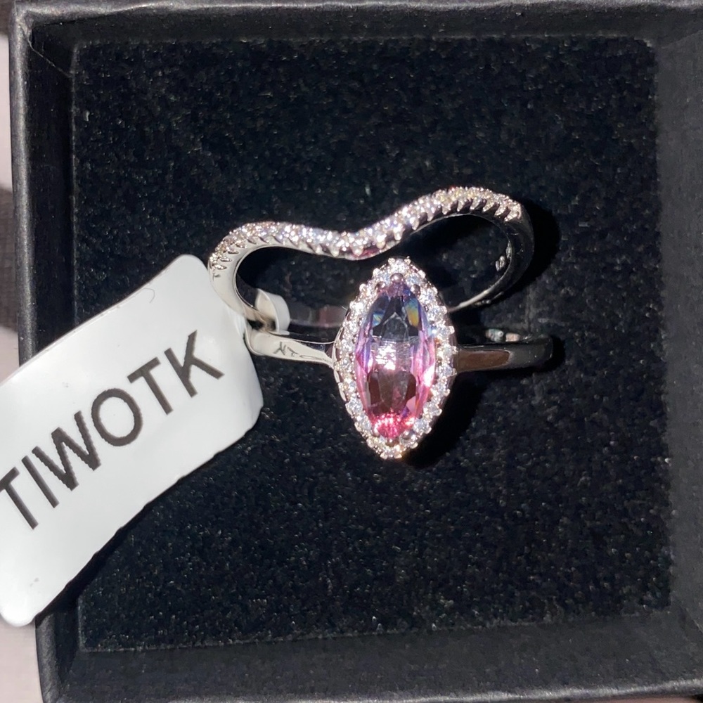Charmed aroma blue,pink ombre silver ring, that comes w/ a band of white stones.